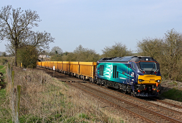 68005 'Defiant' passes the foot crossing west of Narborough Station heading towards Wigston North Junction on 8.4.15 with 6U76 0859 Crewe Bas Hall S.S.M. - Mountsorrel Sdgs empty yellow IOA wagons