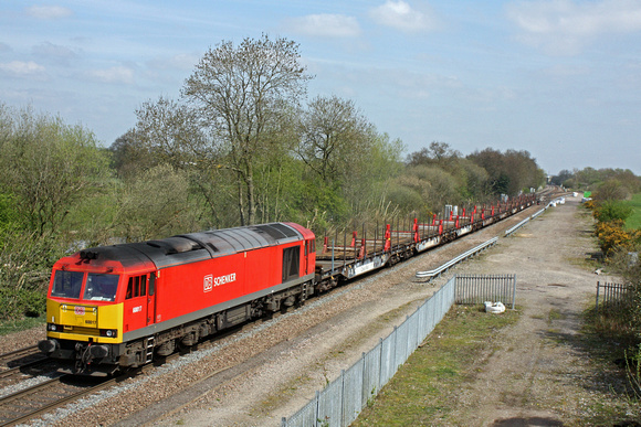 60017 in DB Schenker livery rumbles paast Stenson Junction on 20.4.15 with 6X01 1017 Scunthorpe Trent T.C. - Eastleigh East Yard welded rail train