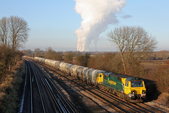 70011 at Normanton on Soar, MML north of Loughborough on 11.12.12 with 6L87 1237 Earls Sdgs - West Thurrock loaded small PCA  cement tanks. Note the plume of steam filling the sky from Ratcliffe P.S.