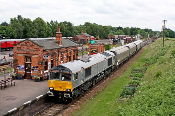 GBRf 66749 in grey livery with 4 biomass hoppers hurries through Quorn & Woodhouse station, GCR on 3.7.13 at 75mph on brake and noise testing between Swithland and Little Woodthorpe
