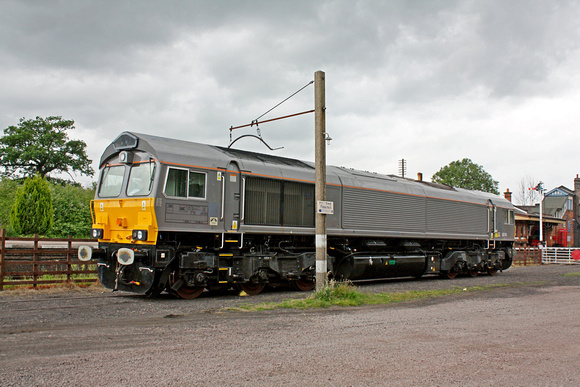 GBRf 66749 in grey livery at Quorn & Woodhouse Yard, GCR on 1.7.13 having arrived by low loader from Brush Traction. The 66 and 2 new W H Davis Biomass Hoppers are to be used for noise testing on GCR