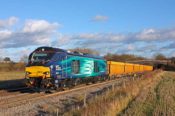 Latest DRS Class 68 in service No 68017  'Hornet' in sparkling condition passes Stenson Bubble nr Stenson Junction  on 20.11.15 with 6U77 1342 Mountsorrel Sdgs - Crewe Bas Hall S.S.N. loaded  yellow I