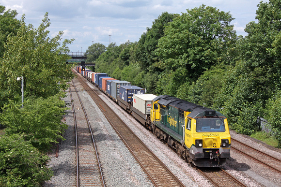 Freightliner 70010 at its signal check awaiting time at Long Eaton just south of Toton Yard on 21.6.16  with 4O95 12.12 Leeds F.L.T. - Southampton M.C.T. liner