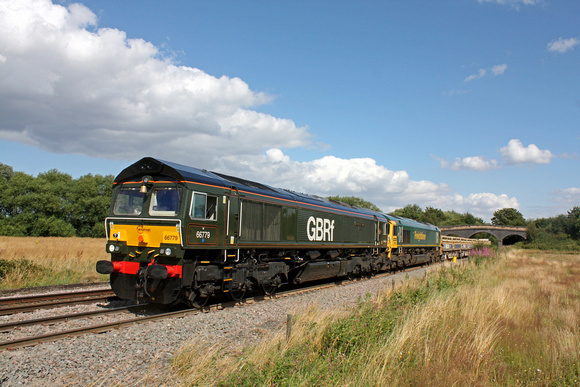 GBRf 66779 'Evening Star' in lined passenger express 'brunswick green' drags 66561 (DIT) at Stenson Bubble near Stenson Junction on 8.8.16 with 6K50  1513 Toton North Yard - Crewe Bas Hall departmenta