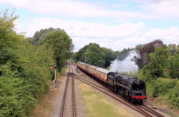 BR Standard Class 9F 92214 approaches Quorn and Wodehouse Station on 1.7.23 with 1400 Loughborough - Leicester North GCR service