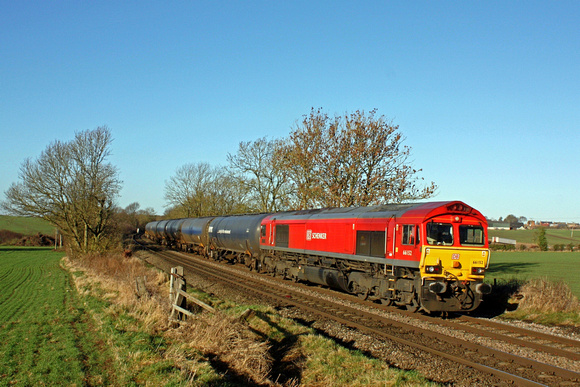 DB Cargo 66152 'Derek Holmes Railway Operator' in DB Schenker red livery passes Chellaston nr Castle Donington on 2.1.17 with 6E54 1034 Kingsbury Oil Sdgs - Humber Oil Refinery empty oil tanks