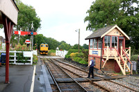 Class 33 No 33202 ' Dennis G Robinson'  approaches Tenterden Town Signal Box with the signalman  waiting to take the token on 5.8.23 working 0950 Northiam to Tenterden service on the Kent and East Sus