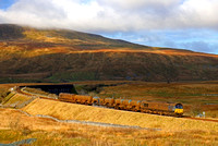 Looking somewhat worse for wear DRS Class 66's 66434  & 66433 head towards Ribblehead Viaduct on 26.11.18 with 3J11 1706½ Carlisle Kingmoor Tmd(Drs) to Carlisle Kingmoor Tmd(Drs) RHTT working