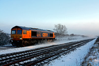 The low sun glints on 66715 at a snowy Cossington, MML on 22.12.10 with 4E80 1311 Hotchley Hill (East Leake) - West Burton Power Station empty gypsum containers