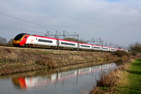 Virgin Pendolino 390017  alongside the Oxford Canal at Ansty heading towards Nuneaton on 2.3.11. with 1407 London Euston - Liverpool Lime Street service
