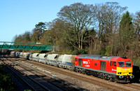 DB Schenker liveried 60007 glints in the morning sun at Barrow Upon Soar near Loughborough on 25.11.11 with 6L75 0849 Peak Forest - Ely Papworth loaded aggregate hoppers