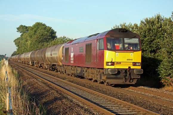 60040 approaches Attenborough heading towards Nottingham on 12.08.10 with 6E46 0435 Kingsbury Oil Sdgs -  Lindsey Oil Terminal empty bogie tanks in early morning sunshine