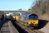 66430 in latest DRS  blue livery ambles through South Wigston Station  on 16.2.16 with 6U76 0859 Crewe Bas Hall S.S.M. - Mountsorrel Sdgs empty yellow Network Rail IOA wagons