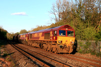 DB Cargo Class 66 Loco's 66207 & 66155 power towards St Fagans L.C. near Cardiff on 21.4.24 in the low sun with 6B05 1836 Llanwern Exchange Sdgs to Margam T.C. steel train