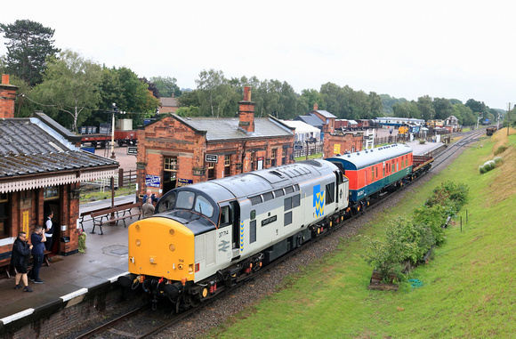 37714 arrives at a wet Quorn & Woodhouse station with Test Car 2 coach running in authentic 1980s test train formation on 22.7.23 with 1150 Swithland to Loughborough train at GCR Quorn Wagon and Wagon