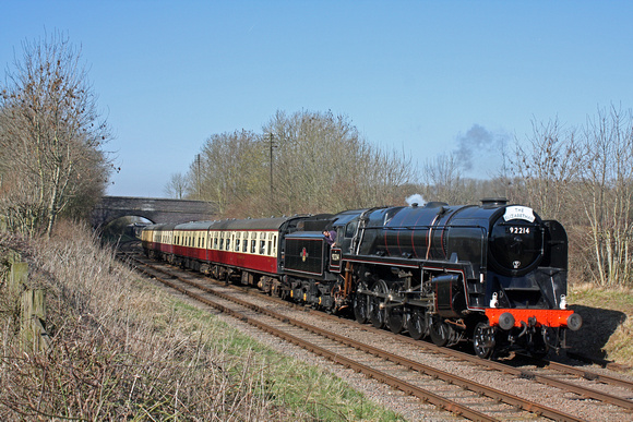 British Railways Standard Class 9F 2-10-0 No.92214 'Cock o the North' is seen between Kinchley Lane & Swithland Reservoir  9.3.14 with 1315 Loughborough - Leicester North 'The Elizabethan' GCR dining
