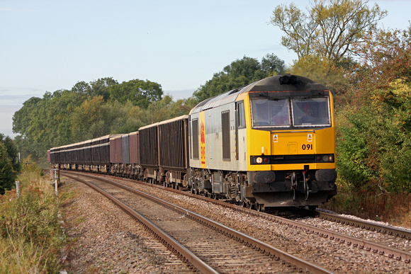 60091 in EWS two tone grey livery approaches  Washstones Farm Crossing, Frisby on 25.09.09 heading towards Melton Mowbray with 6L76 0705 Stud Farm - Bury St Edmunds loaded JNA & MEA stone wagons