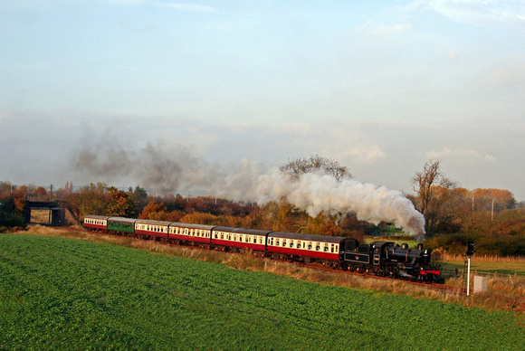BR standard class 2 2-6-0 No 78019 at Woodthorpe from the A6 bypass road on 4.11.07 with 15.15 Loughborough - Leicester North service in low sun