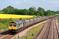 66302 in Fastline livery passes a beautiful yellow rape seed field at Hathern, MML on 16.6.09 with 6A63 1544 Daw Mill Colliery - Ratcliffe Power Station loaded coal hoppers