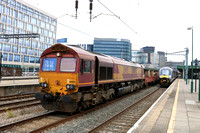 DB Cargo 66092 waits at Cardiff Central on 29.4.24 with 6B10 0920 Newport Docks to Margam T.C. (Steel) whilst GWR 800010 arrives with1B08 0918 Paddington to Cardiff Central service