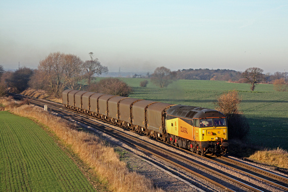 Colas Rail 47727'Rebecca' at Portway heading towards Tamworth   on 16.1.12 with 6M08 1152 Boston Docks - Washwood Heath with loaded steel carriers running via Burton Upon Trent in lovely low sunlight