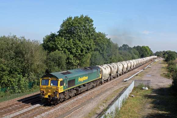 Freightliner 66603 accelerates away from the branch line at Stenson Junction on 13.9.16 with 6G65  0919 Hope (Earles Sidings) - Walsall Freight Terminal loaded PCA cement tanks