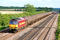60018 in EWS red and gold livery on the slow line at Cossington north of Syston, MML on 27.7.07 with 6E38 1340 Colnbrook Elf Oil Sdgs - Lindsey Oil Refinery empty bogie tanks