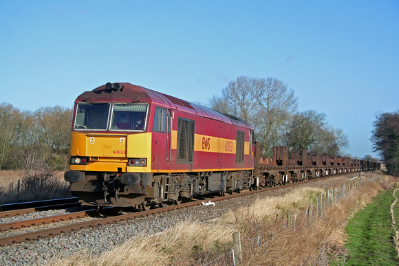 EWS livery 60023 at East Goscote heading towards Syston East Junction on 01.02.08 with 6V92 1010 Corby BSC - Margam empty steel coil wagons