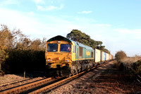 Freightliner Class 66 No 66517 approaches Levington foot crossing on the Felixstowe Branch on 19.10.22 with 4M89 1613 Felixstowe North F.L.T. to Ditton (Oconnor) Fliner Intermodal
