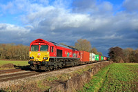 DB Cargo 66113 with its Delivering for Key Workers Vinyls is seen at East Goscote heading towards Syston East Junction on 13.1.23 working 4M79 0800 Felixstowe South Dbc to East Mids Gateway Tml Dbc In