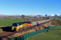 Colas Rail Freight Class 70 No 70806 powers past Docker, Cumbria WCML on 16.1.23 with 6M38 0946 Ravenstruther Colas to Longport Lr Colas loaded Land Recovery Mega Box wagons