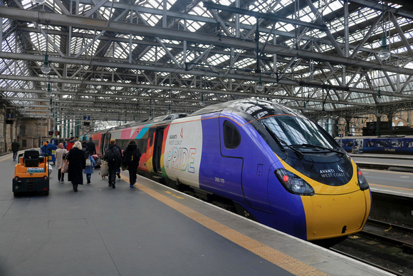 Passengers hurry to board Avanti West Coast Pride Pendolino No 390119 waits at Glasgow Central Station on 11.2.23 with 1M13 1240 Glasgow Central to London Euston service