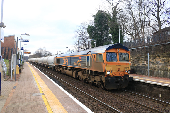 GBRf Class 66 No 66737 'Lesia' passes through Maryhill Station on an extremely dull 13.2.23 with 6E45 0807 Fort William Alcan Gbrf to North Blyth Alcan Gbrf empty Alumina tanks