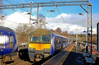 A work stained ScotRail Class 320 No 320304 arrives at Anniesland Station on 15.2.23 with 2E70 1038 Balloch to Airdrie service