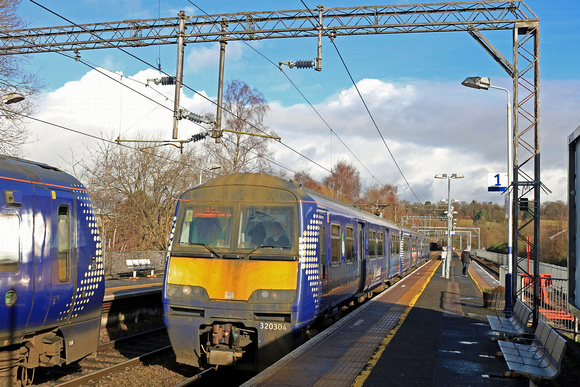 A work stained ScotRail Class 320 No 320304 arrives at Anniesland Station on 15.2.23 with 2E70 1038 Balloch to Airdrie service