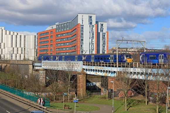 ScotRail 334039 crosses the bridge over River Kelvin near the Riverside Museum, Partick on 24.2.23 with 2H56 1152 Helensburgh Central to Edinburgh meets ScotRail 318265 leading 2F25 1117 Cumbernauld t