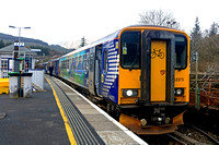 ScotRail Class 153 No 153373 with bicycle carrying vynyls and Scotrail Class 156 No 156458 wait at Crianlarich Station,  West Highland line on 17.3.23 with 1Y25 1036 Glasgow Queen Street to Oban servi