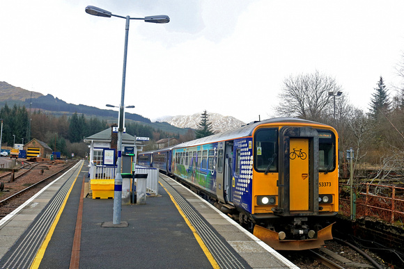 ScotRail Class 153 No 153373 with bicycle carrying vynyls and Scotrail Class 156 No 156458 wait at Platform 2, Crianlarich Station, West Highland line on 17.3.23 with 1Y25 1036 Glasgow Queen Street to