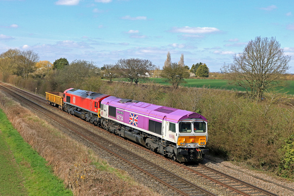 GBRf Class 66 No 66734 ‘Platinum Jubilee' in special livery drags DB Cargo 66078 and one low wagon on 3.4.23 with 6D44 1113 Bescot Up Engineers Sdgs to Toton North Yard departmental