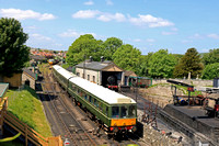 Swanage Railway Class 117 DMU (consisting of vehicles W51356, W59486 and W51388) passes Swanage engine shed on 24.5.23 with 2C19 1119 Wareham to Swanage link service possibilly in its last year