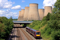 EMR Class 170 No 170517 passes Ratcliffe On Soar, with Ratcliffe Power Station behind on 21.6.23 with 2L66 1241 Grimsby Town to Leicester service