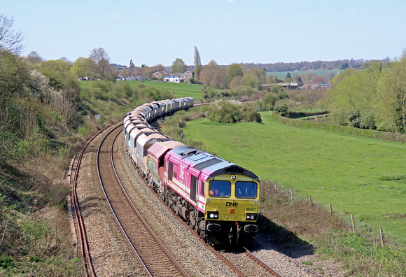 Freightliner Class 66 No 66587 'AS ONE, WE CAN' in One Pink Livery at Hungerford Common on 20.4.23 with late running 6M20 1038 Whatley Quarry F Liner Hh to Churchyard Sdgs (Flhh) loaded hoppers (SMB)