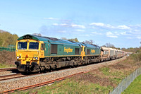 Freightliner Class 66 No's 66540 'Ruby' & 66537 race alongside Hungerford Common on 20.4.23 with a Jumbo 7C77 1220 Wembley Receptions 1-7 to Merehead Quarry (Fhh) empty box hoppers