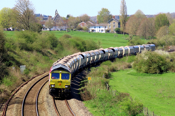 Freightliner Class 66 No 66587 'AS ONE, WE CAN' in One Pink Livery at Hungerford Common curve on 20.4.23 with late running 6M20 1038 Whatley Quarry F Liner Hh to Churchyard Sdgs (Flhh) loaded hoppers