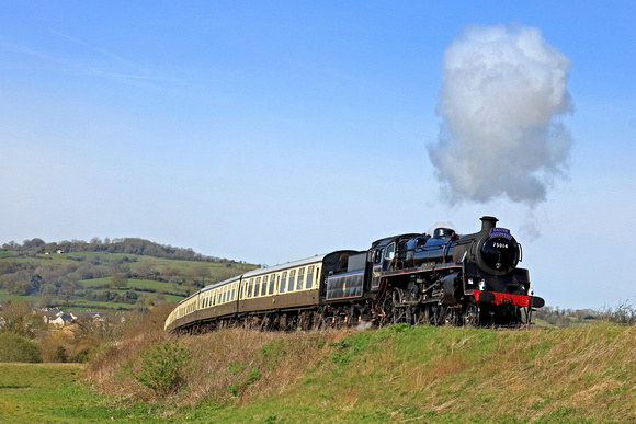 Standard class 4 4-6-0 no. 75014 'Braveheart' on three-month visit Dartmouth Steam Railway is seen at Chicken Curve, Winchcombe on 8.4.23 with 1000 Cheltenham to Broadway GWSR service
