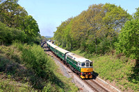 D6515 'Lt Jenny Lewis RN' (33012)  departs leafy Harmans Cross on 13.5.23 with 1R05 1132 River Frome Viaduct to Swanage service  at the Swanage Railway Diesel Gala May 2023. 45108 at rear