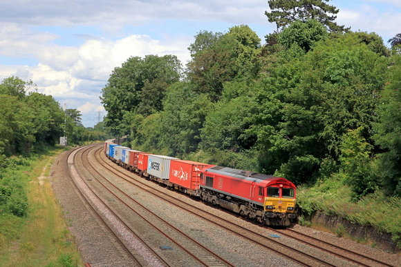 DB Cargo Class 66 No 66017 in red livery ambles past  Barrow upon Soar, MML on 29.6.23 with 4L38 1057 East Mids Gateway Tml Dbc to Felixstowe Central Dbc Intermodal