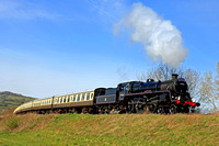 Standard class 4 4-6-0 no. 75014 'Braveheart' on three-month visit Dartmouth Steam Railway, Devon is seen at Chicken Curve, Winchcombe on 8.4.23 with 1000 Cheltenham to Broadway GWSR service
