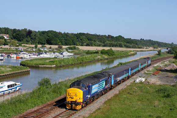 DRS 37419 'Carl Haviland' t&t 37405 with The  Greater Anglia short set passes St Olaves Marina on 6.6.16 at Haddiscoe with 2J83 1548 Lowestoft - Norwich service