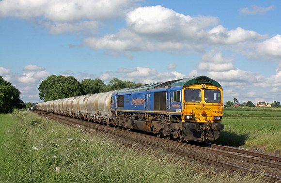 Freightliner 66623 'Bill Bolsover' in blue livery passes East Goscote heading towards Syston East Junction on 20.6.16 with 6M92  1223 West Thurrock Sidings Fhh -Tunstead Sdgs empty cement tanks